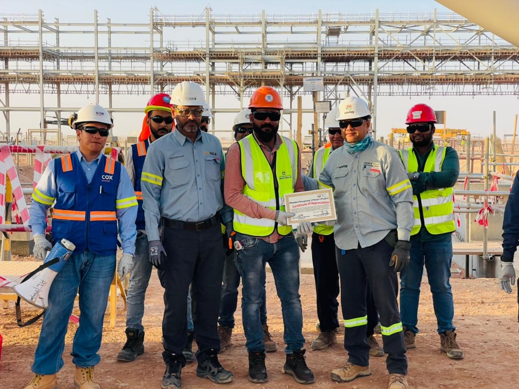 Construction engineers reviewing blueprints outdoors